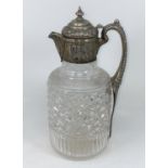 An Edwardian cut glass claret jug with hallmarked silver chased lid, collar and handle, London 1903