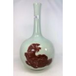 A Chinese ceramic slim neck bottle vase decorated with red glaze temple dogs, height 40cm (