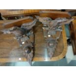 A 19th pair of Black Forest wall brackets carved as eagles