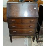 A 1930's oak bureau with fitted interior and 3 drawers