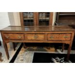 An 18th century crossbanded oak small dresser base, 3 frieze drawers with swan neck handles, on