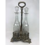 A 19th century 3 bottle decanter stand with extensive vine relief decoration, with 3 vine etched