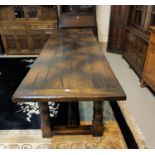 An 18th century style distressed oak refectory table in the manner of Titchmarsh & Goodwin, with
