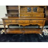 An 18th century style distressed oak dresser base in the manner of Titchmarsh & Goodwin, with 3