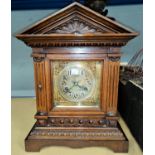 An Edwardian mantel clock in architectural oak case, with strike