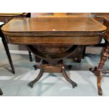 A Regency period crossbanded rosewood card table with rounded rectangular fold-over top, baize lined