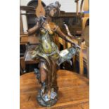 An Art Nouveau patinated spelter figure of a young woman with pen and scroll, height 47cm (finger