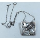 Georg Jensen, a square framed silver pendant necklace designed by Arno Malinowski, a pair of birds