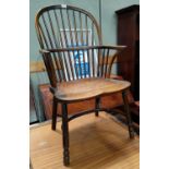 A 19th century elm Windsor armchair with hoop and stick back and solid seat, on turned legs with