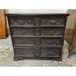 An early 18th century oak chest, the 4 drawers with carved fronts, 94 cm