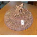 A cast iron sundial; a cherub weather vane; a swing sign: "Antiques & Collectibles"