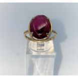 A 9 carat hallmarked gold dress ring set with large oval cabochon garnet, size O, 4.5gm