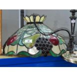 A Tiffany style large ceiling pendant lightshade with relief decoration of fruit