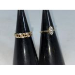A 9 carat hallmarked gold ring set marquise cut diamond simulant; a 9 carat hallmarked gold dress