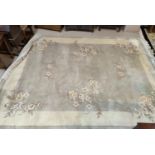 A sage green ground Chinese carpet 365x275cm