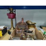 A 19th century brass oil lamp with cranberry reservoir; a copper kettle; brassware