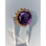 A yellow metal dress ring set with circular facetted amethyst, Middle Eastern marks, tests as 14