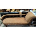 A Victorian golden oak chaise longue with carved back rail and studded turned column decoration