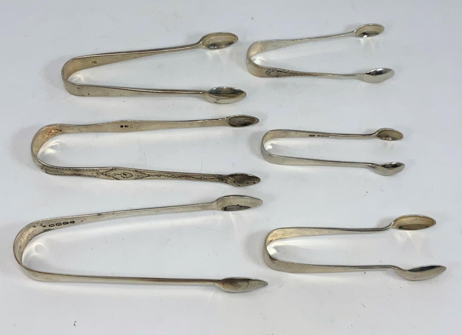 Two Georgian hallmarked silver pairs of sugar tongs; 4 others; various dates, 5 oz