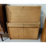 A mid century teak bureau with fall front