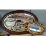 A 1920's oval wall mirror in mahogany frame; 2 others