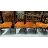 An Edwardian set of 4 salon chairs in carved mahogany with rust velvet upholstery