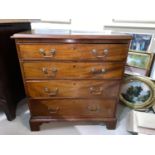 A Georgian mahogany bachelor's chest of 4 long drawers with brass swan neck handles, on bracket