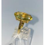 A lady's dress ring set with large oval Topaz type stone, on yellow metal shank stamped 18ct, size