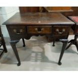 An 18th century oak country made lowboy with 3 frieze drawers and shaped apron, on club legs,