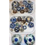 A large collection of Chinese vase lids, various shapes and sizes
