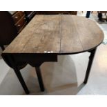 A Georgian oak dining table with D ends, on gate legs, extended length 142 cm