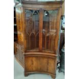 A mahogany full height corner cupboard with concave front, by Reprodux