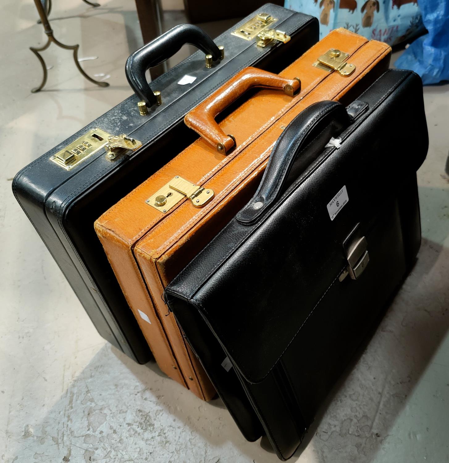 Two leather attache cases; etc.