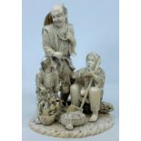 A finely carved late 19th / early 20th century Japanese ivory family group of fisher folk, the man