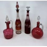 Two 19th century ruby overlaid decanters (1 replacement stopper); 2 cranberry claret jugs