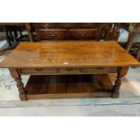 A reproduction oak two tier coffee table with drawers.