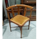 An Edwardian tub armchair in inlaid mahogany