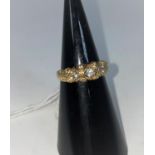 A 9 carat hallmarked gold gypsy style ring set 7 diamond simulants, 3.3 gm