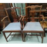 A 19th century pair of mahogany carver chairs in the Chippendale style, with pierced vase splats and