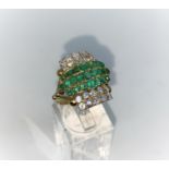 A 1970's diamond and emerald dress ring with 4 rows of 5 diamonds and 3 rows of emeralds, shank 22