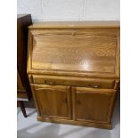 A vintage teak bureau with fitted interior, single drawer and double doors
