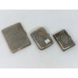 Three hallmarked silver cigarette cases, one engine turned and two chased, Birmingham 1941, 119 &