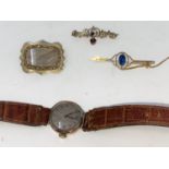 A 1930's ladies 9 carat hallmarked gold wristwatch on leather strap; 2 Edwardian yellow metal bar