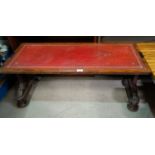 A reproduction mahogany coffee table with leather top; a similar drop leaf table