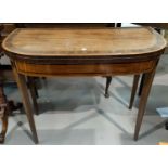 An early 19th century mahogany card table with inlaid decoration to the 'D' end fold-over top, on
