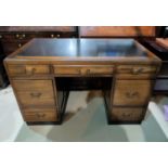 A mid 20th Century pedestal desk with 7 drawers