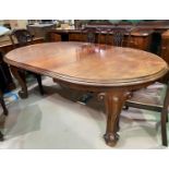 A Victorian mahogany heavy wind-out dining table with oval top, on knurled feet and castors,