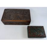 A Chinese cinnabar and black colour lidded box decorated with temple dogs and another carved