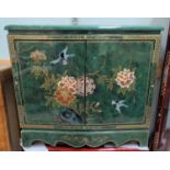 A Chinese double door side cabinet in green high gloss lacquer finish decorated with birds in