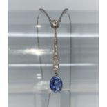 An Art Deco white metal drop pendant with six graduating diamonds to the seam, a diamond to the top